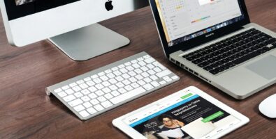 turned on imac beside macbook on table